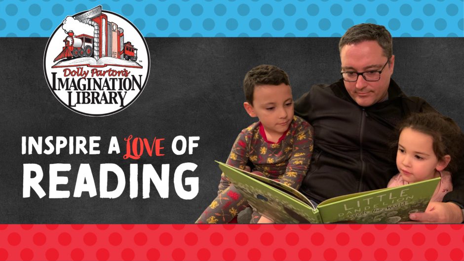 Photo of a Latino dad and his 2 small children reading a book together